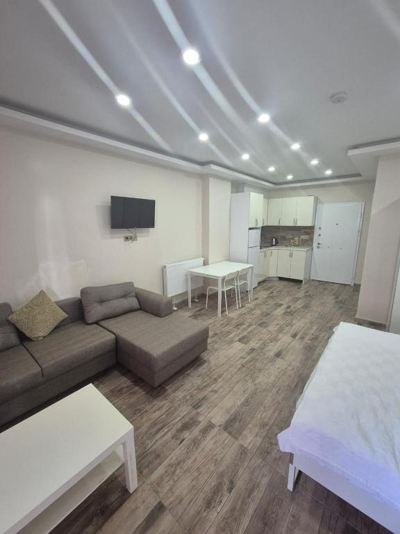 a living room with a couch and a table at Gardi Apart Hotel in Batumi