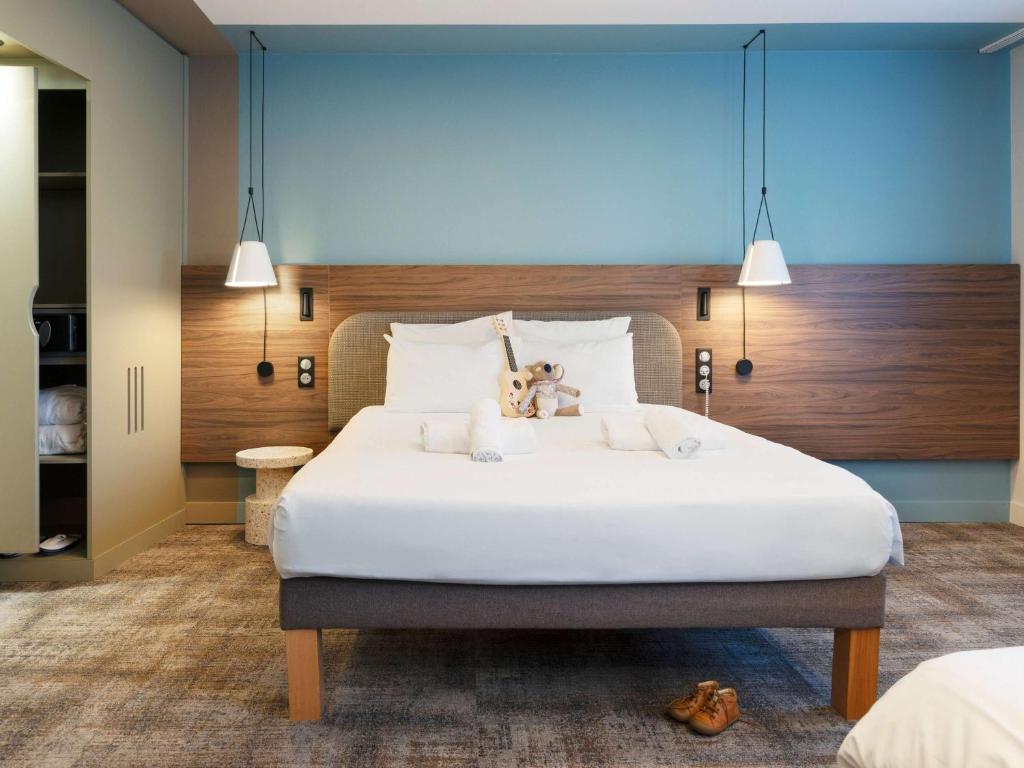 Postel nebo postele na pokoji v ubytování Novotel Suites Nancy Centre