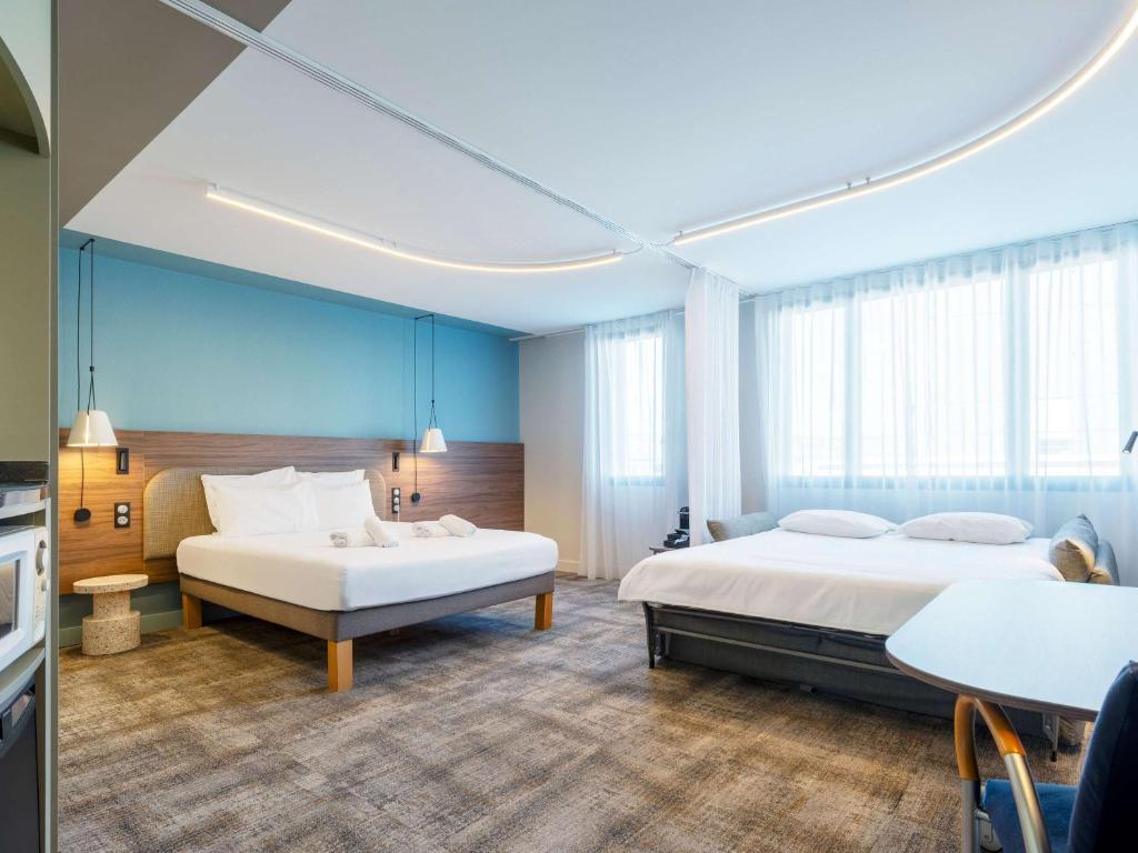 Postel nebo postele na pokoji v ubytování Novotel Suites Nancy Centre