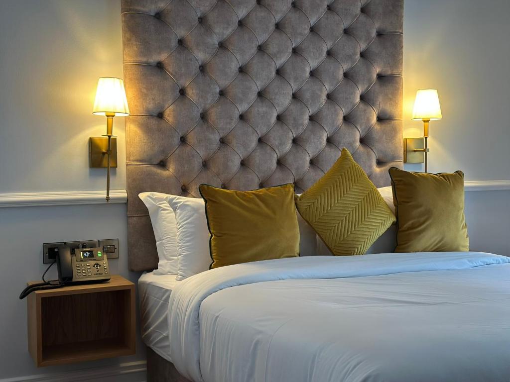 A bed or beds in a room at Sweeney's Hotel 2020 Limited