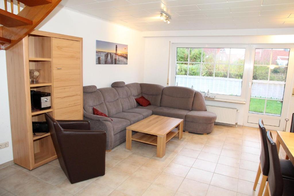a living room with a couch and a table at Seerobbe in Norddeich