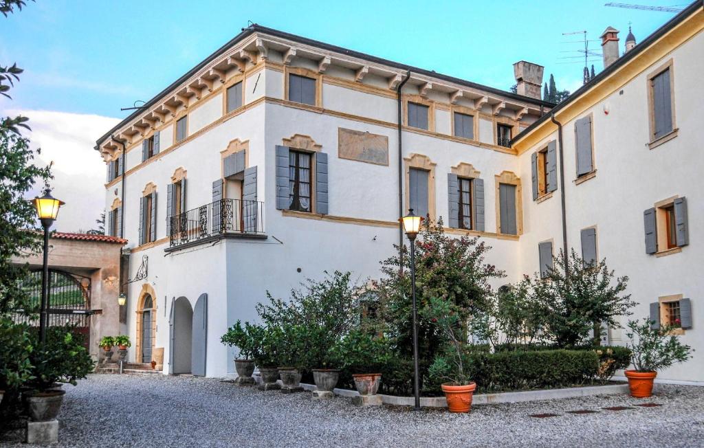 a large white building with plants in front of it at Il Vigneto, Verona, Pool, Wifi in Colognola ai Colli