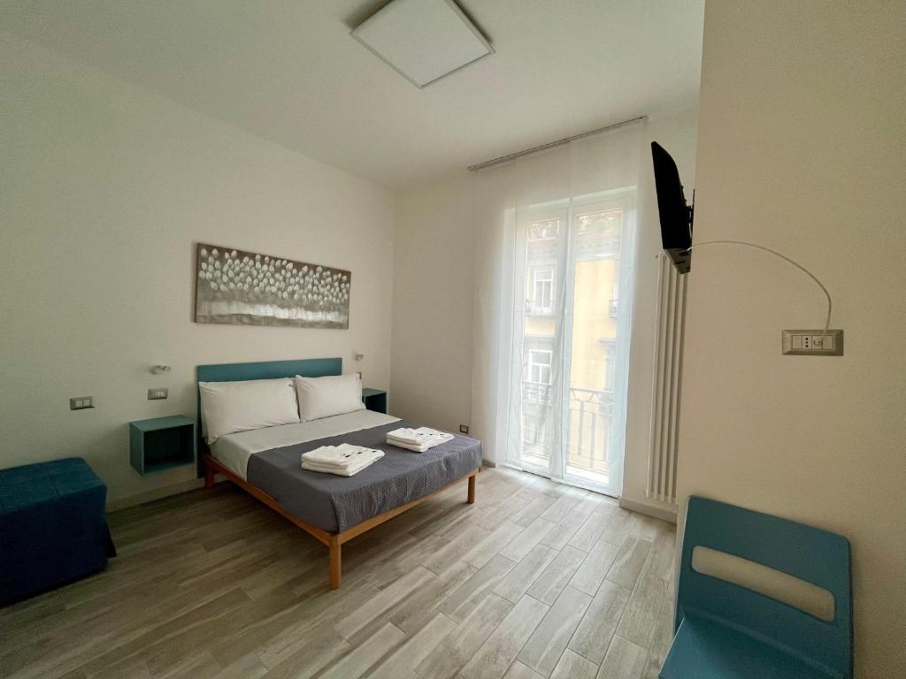 a bedroom with a bed and a tv in it at Prospettiva Medina in Naples