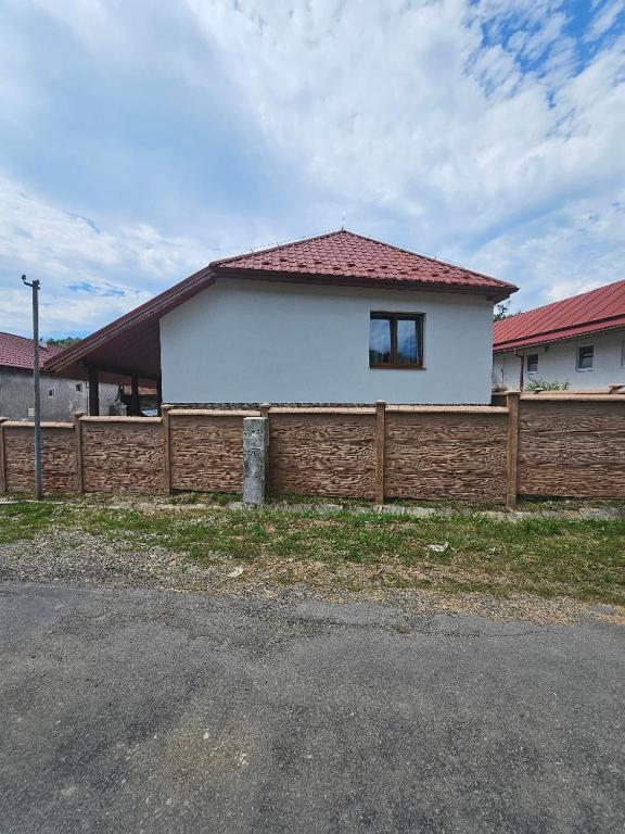 a white house behind a wooden fence at U maďarčika in Prituľany