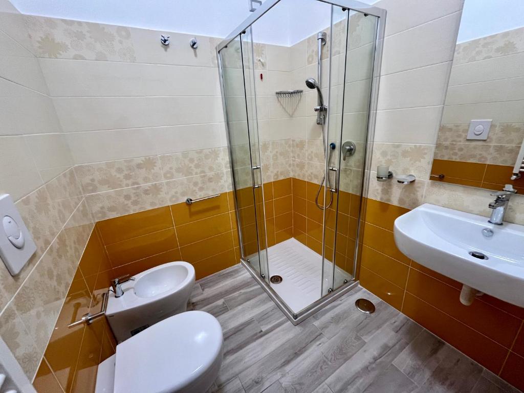a bathroom with a shower and a toilet and a sink at Prospettiva Medina in Naples