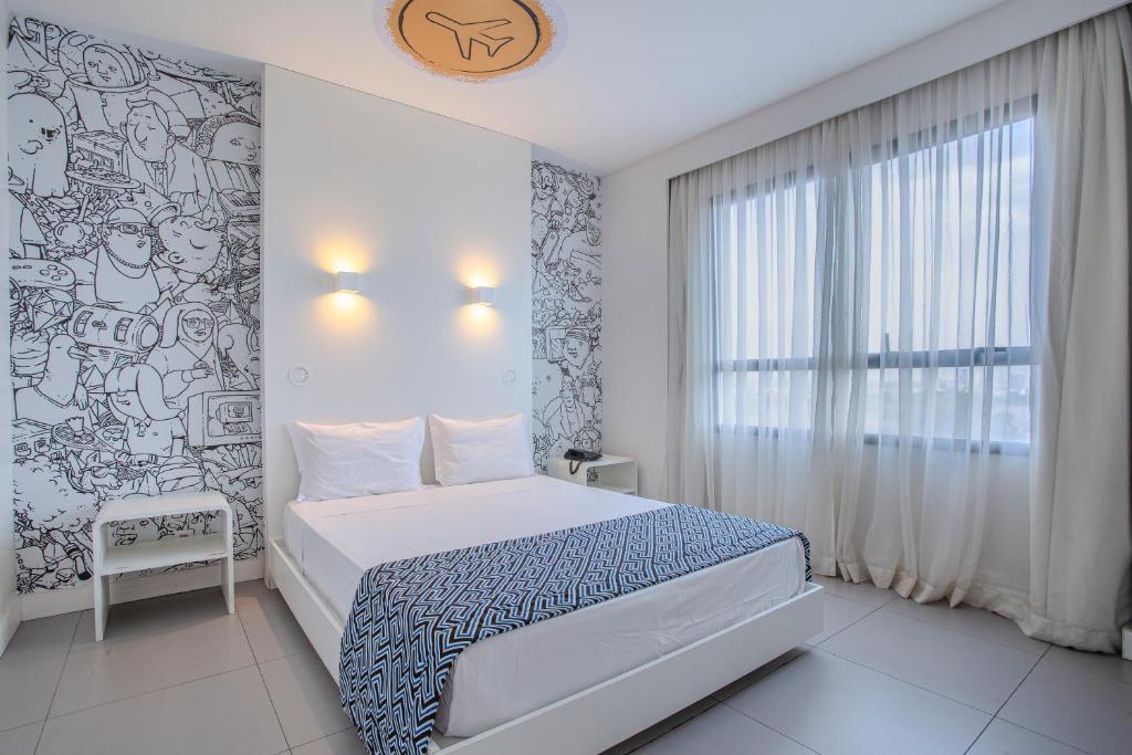 Postel nebo postele na pokoji v ubytování Nacional Inn Palmas