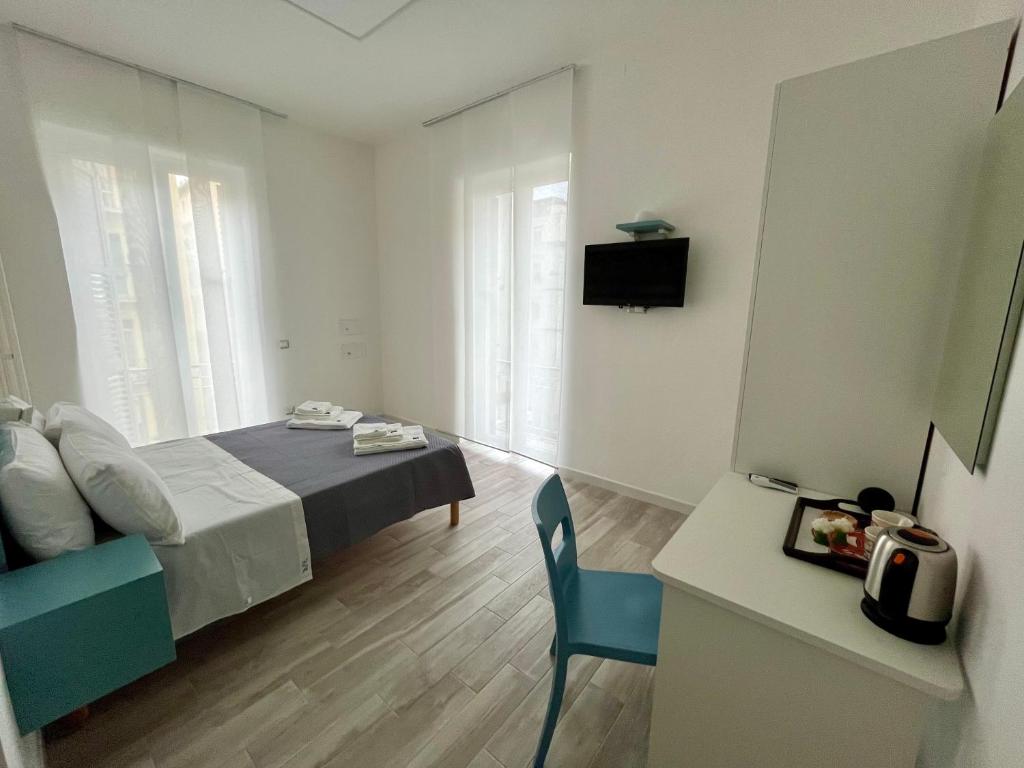 a bedroom with a bed and a desk with a chair at Prospettiva Medina in Naples