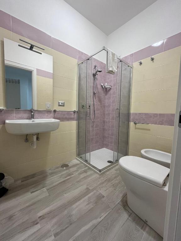 a bathroom with a shower and a toilet and a sink at Prospettiva Medina in Naples
