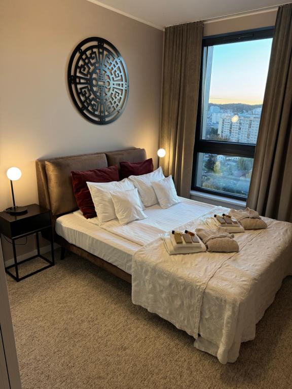 a bedroom with a large bed with a large window at Modern Vero Apartments Portova in Gdynia