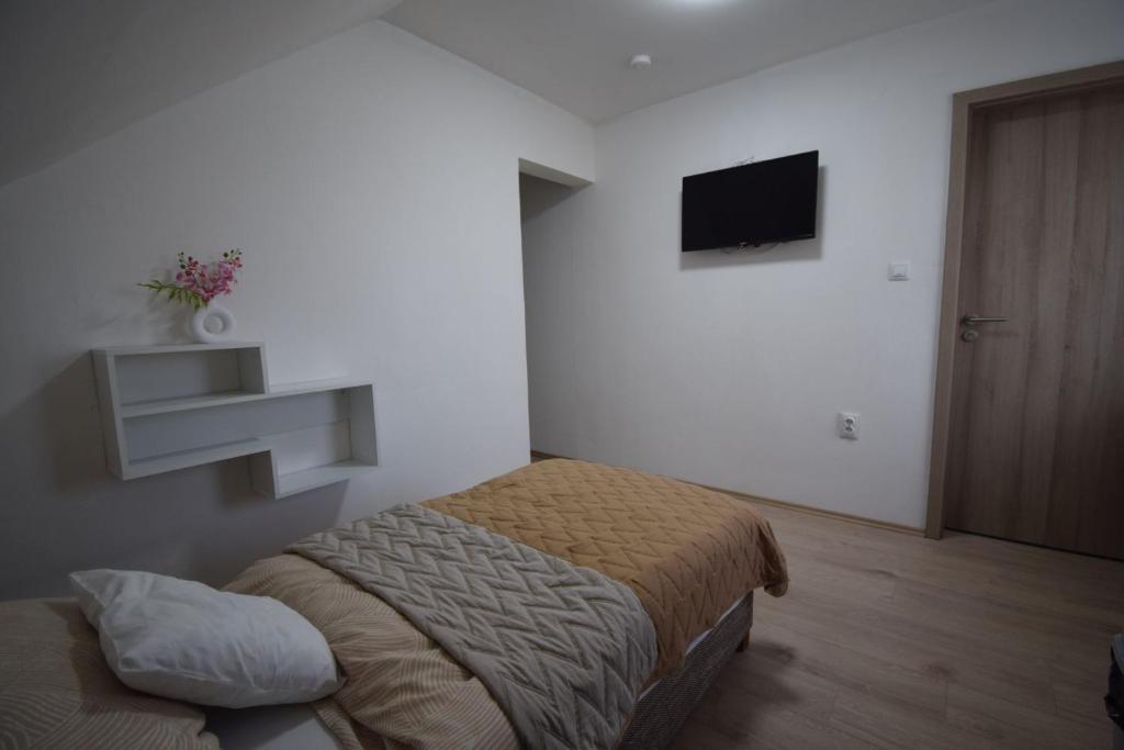 Postel nebo postele na pokoji v ubytování Omni Residence Vendégház