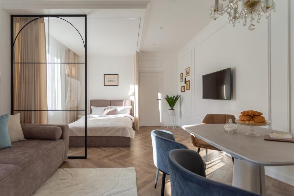 a living room with a bed and a table at "M&D ApartmentsLviv" Ultra Lux Rynok Square, 6person in Lviv