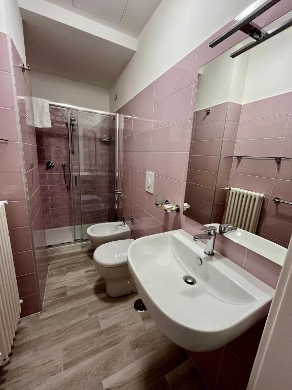 a bathroom with a sink and a toilet and a shower at Prospettiva Medina in Naples