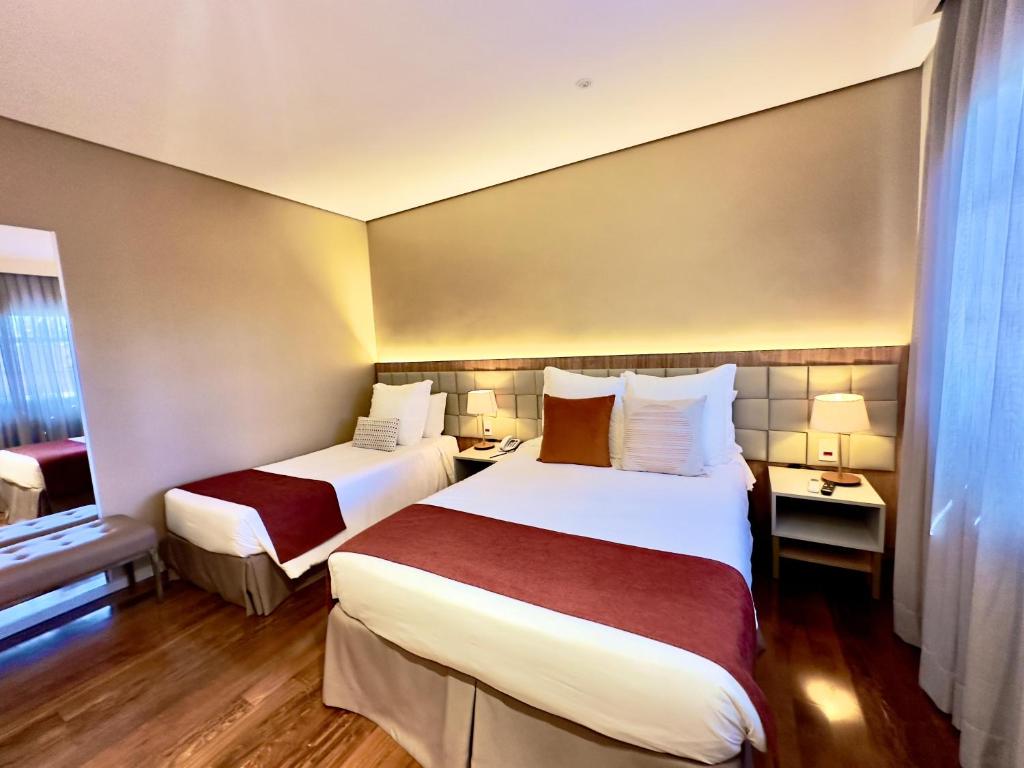 Postel nebo postele na pokoji v ubytování Sanma Hotel