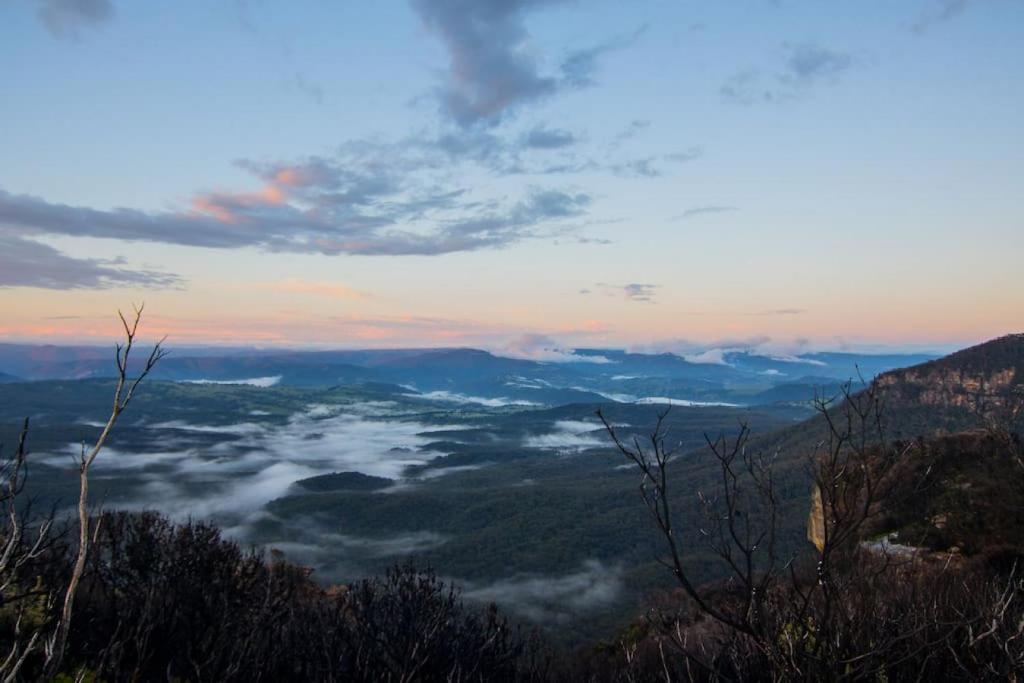 a view of a valley with clouds in the sky at Harmonica - unique modern chic apartment in Katoomba