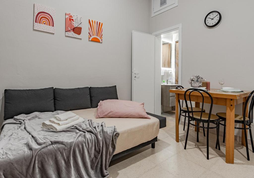 a bedroom with a bed and a desk and a table at Casa Fatmin in Tirrenia