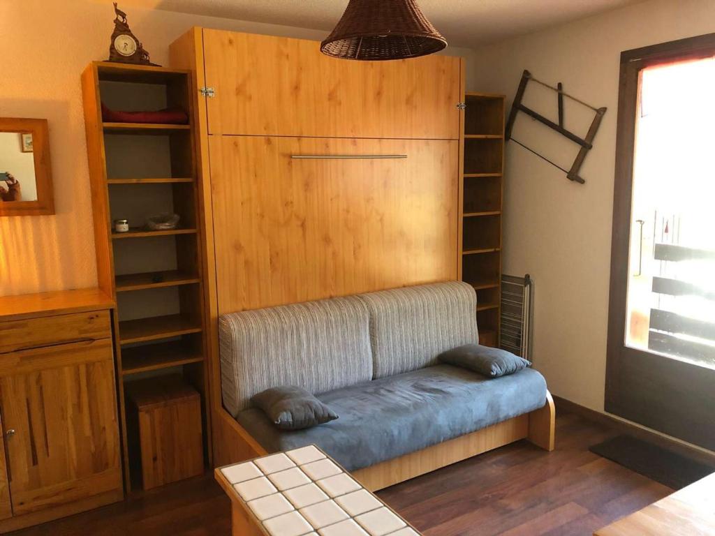- un canapé dans une chambre avec une étagère dans l'établissement Studio cabine ski et rando, 4 pers, pied des pistes, Arêches-Beaufort - FR-1-342-313, à Beaufort