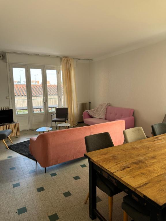 a living room with a couch and a table at Maison ancienne 163 avenue François Verdier albi in Albi