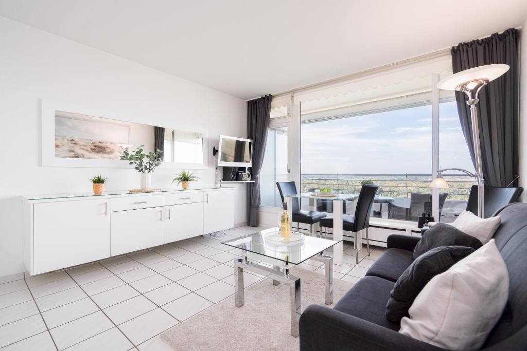 a living room with a couch and a table at TimmenKoje App 290 in Timmendorfer Strand