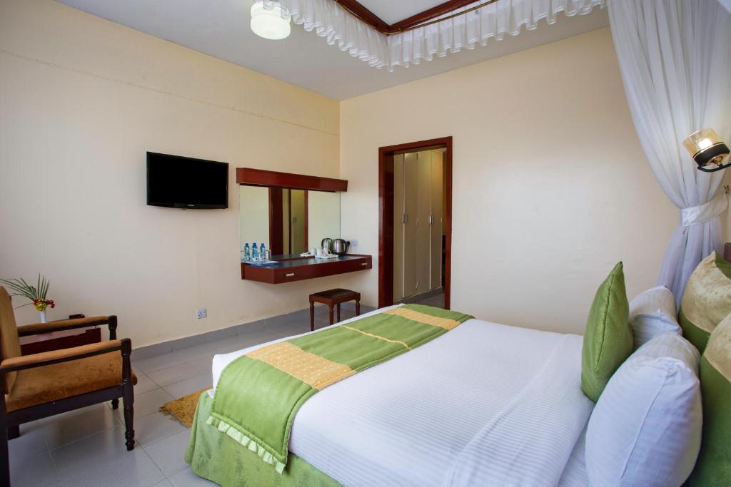 Postel nebo postele na pokoji v ubytování Sirikwa Hotel