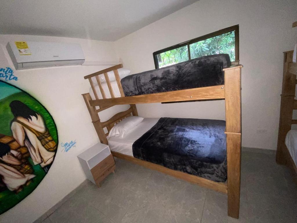 Postel nebo postele na pokoji v ubytování Hostal Aventura Tayrona