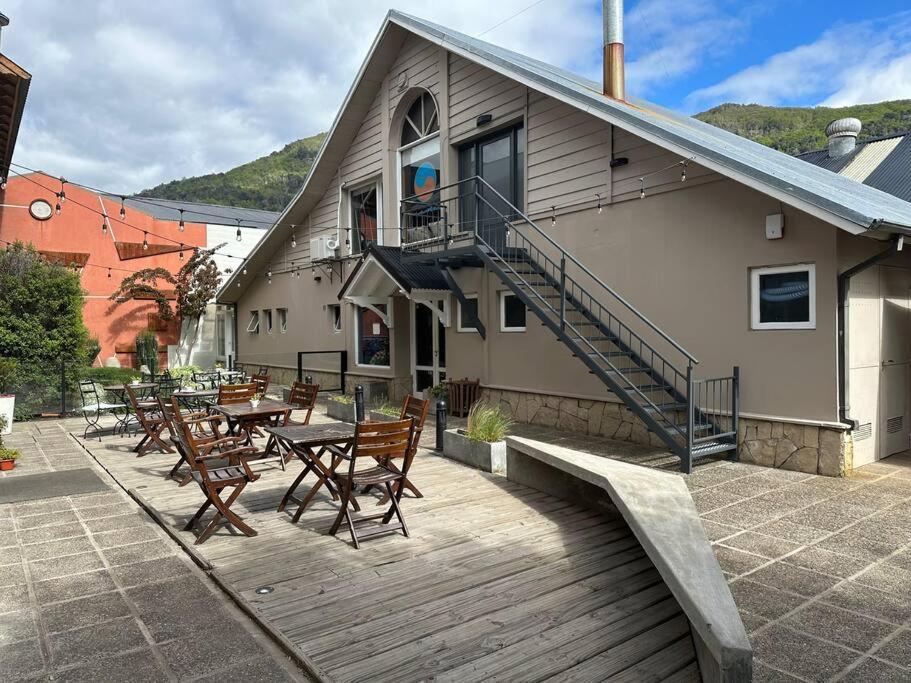a restaurant with tables and chairs on a wooden deck at Departamento Céntrico San Martin de los Andes in San Martín de los Andes