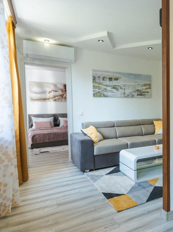 a living room with a couch and a bed at Sweet Home 2 in Sandanski