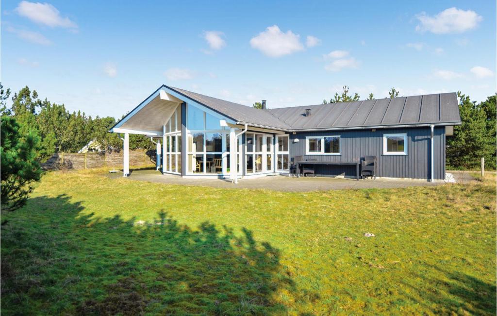 a house on a hill with a large yard at Holiday Home Skippervej in Blåvand
