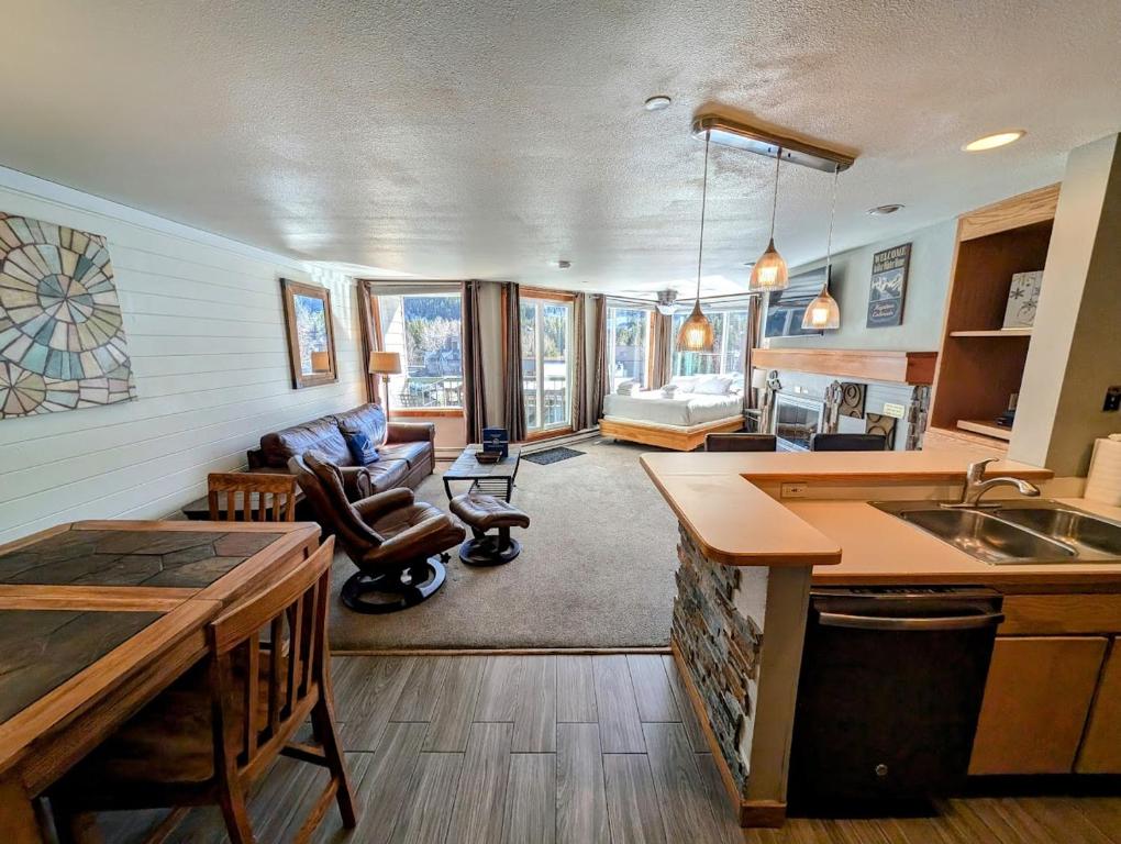 a kitchen and living room with a sink and a couch at Lakeside 1485 by SummitCove Lodging in Colorado in Keystone