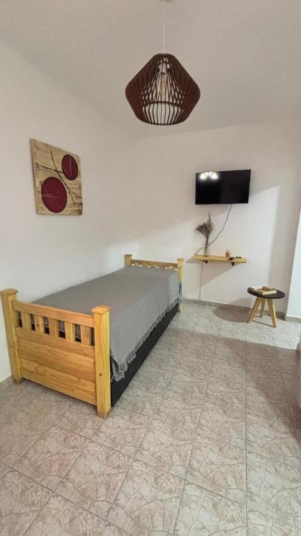 a bedroom with a bed and a television in a room at 760 D Apartamentos in Alta Gracia