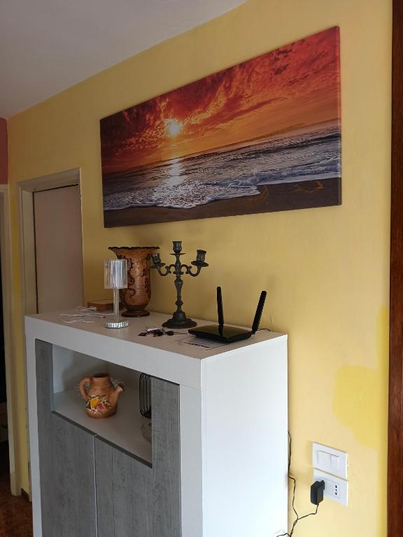 a fireplace in a room with a painting on the wall at Residenza Cornicello in Bardolino