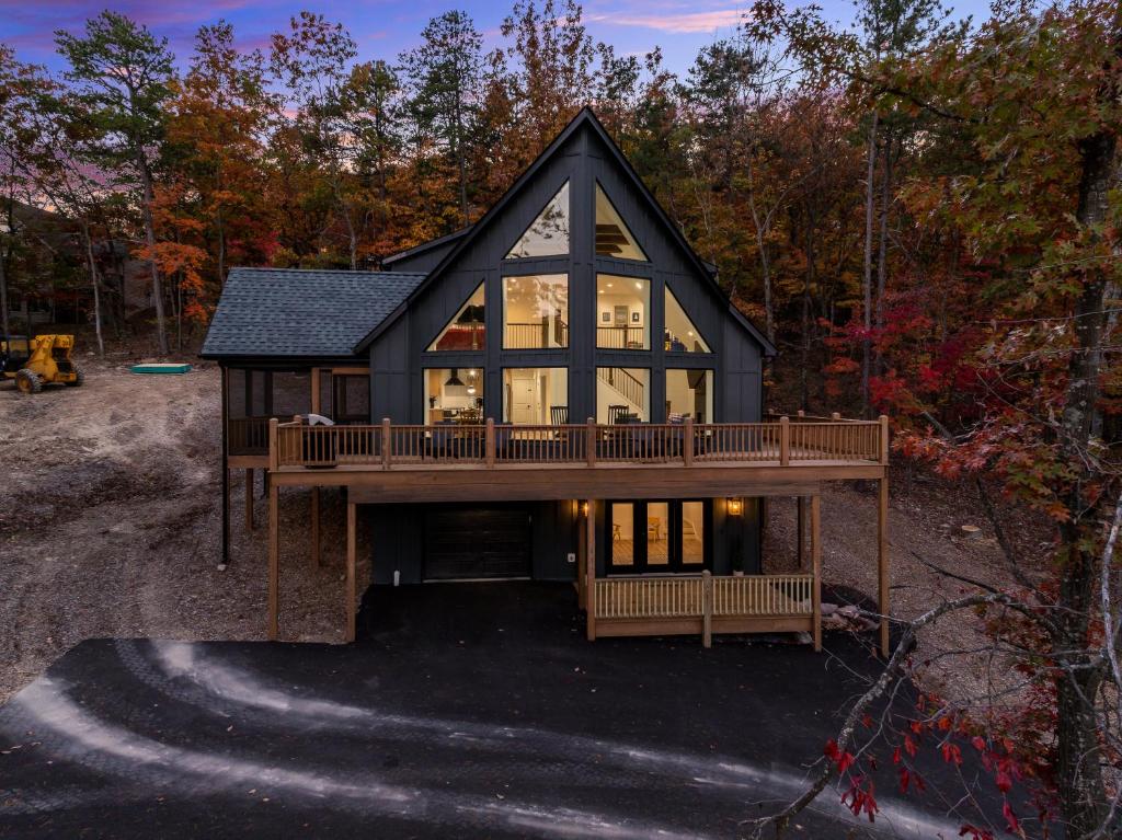 a house with a wrap around deck in the woods at Epic Mtn Views I Luxe 5br Alpine Escape in McGaheysville