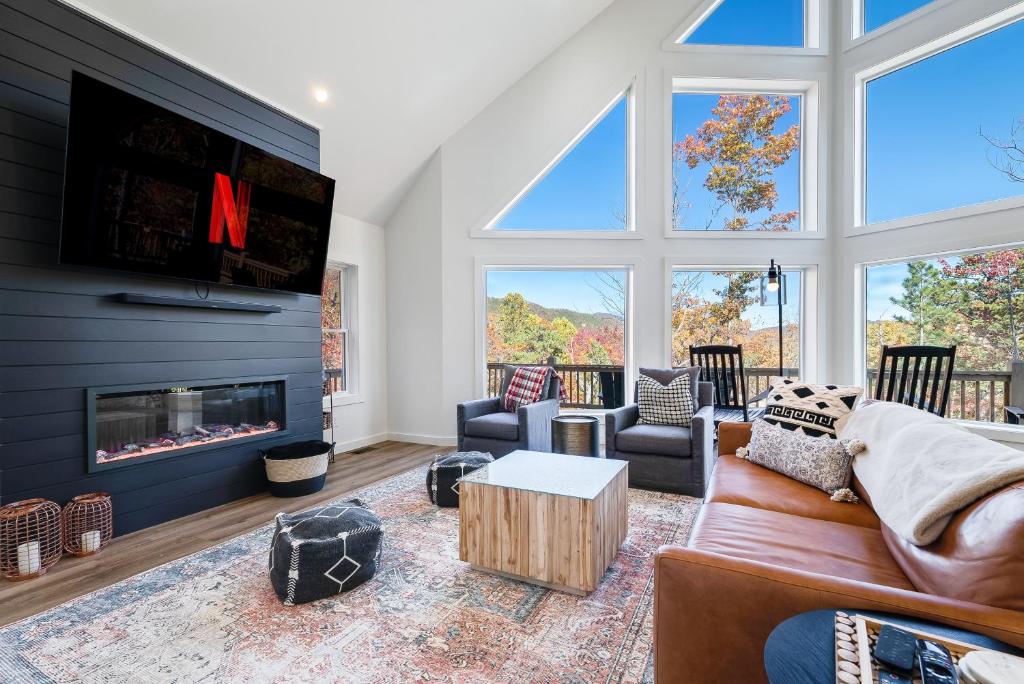 a living room with a fireplace and a tv at Epic Mtn Views I Luxe 5br Alpine Escape in McGaheysville