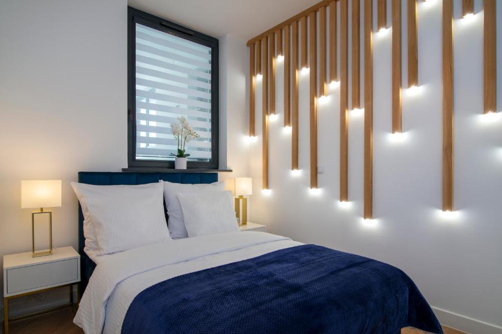 En eller flere senge i et værelse på Slotvin Apartments