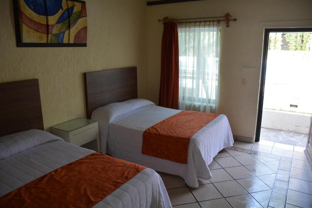 Postel nebo postele na pokoji v ubytování Hotel Posada Virreyes