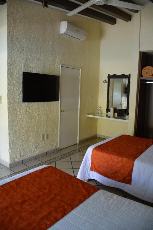 Postel nebo postele na pokoji v ubytování Hotel Posada Virreyes