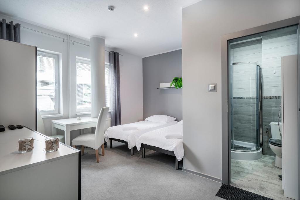 a hospital room with a bed and a bathroom at Keja Aparts - 03 Gdynia Centrum in Gdynia