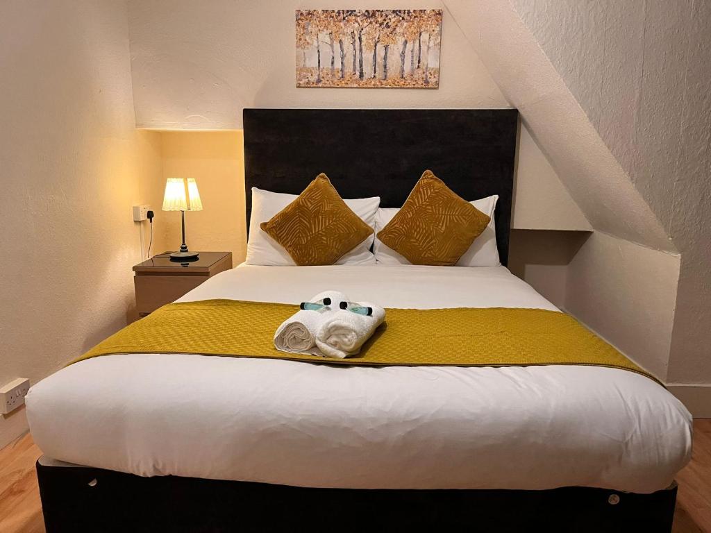 a bedroom with a bed with a teddy bear on it at Eltham Stay in Eltham