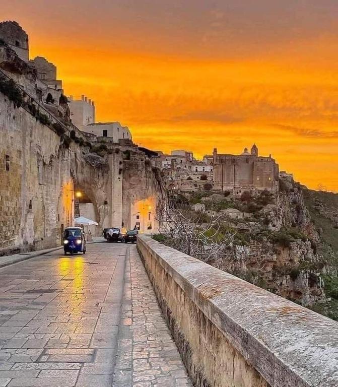 a car driving down a road near a city at Martini Matera 2-luxury apartment in Matera