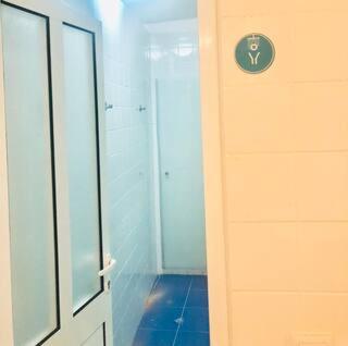 a room with a door and a wall at Private Room 204 in Guest House da Fonte in Figueira da Foz