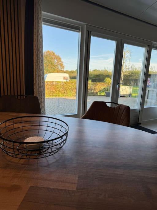 a table with a bowl on top of it at De Paer - Hof van Libeek in Sint Geertruid