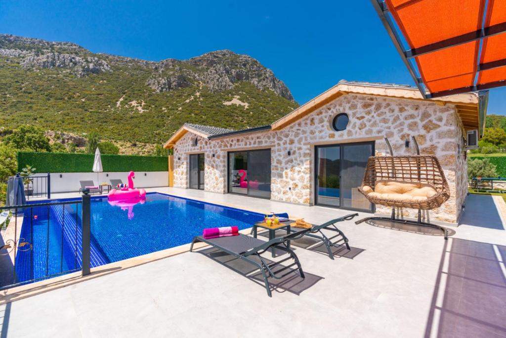 a villa with a swimming pool and a house at Villa estrella in Kaş