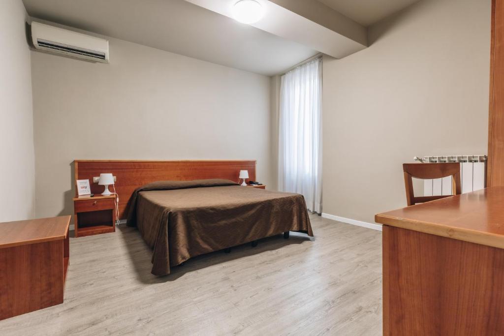 Postel nebo postele na pokoji v ubytování Hotel Astoria