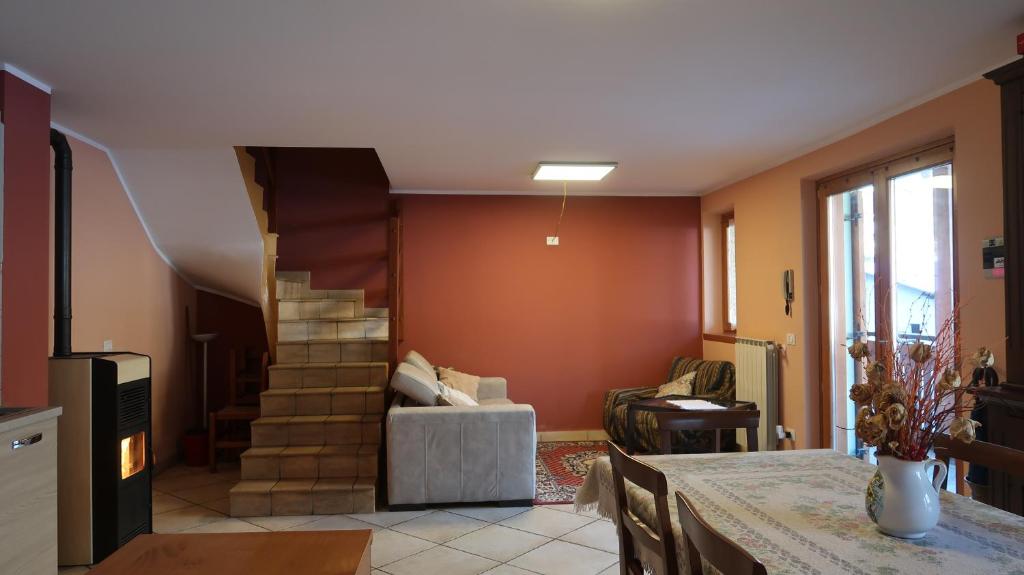 a living room with a staircase and a couch at Casa Temù sulle piste - 8 posti in Temù