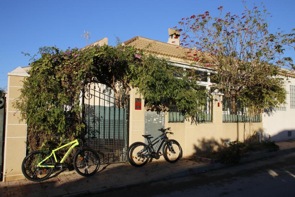 two bikes parked in front of a fence at Casa Fina in Torrevieja
