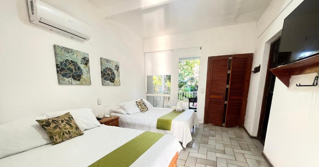 Postel nebo postele na pokoji v ubytování Coral House SAI