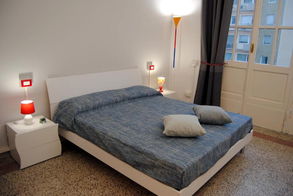 a bedroom with a bed with two pillows on it at Alloggio turistico in Pisa