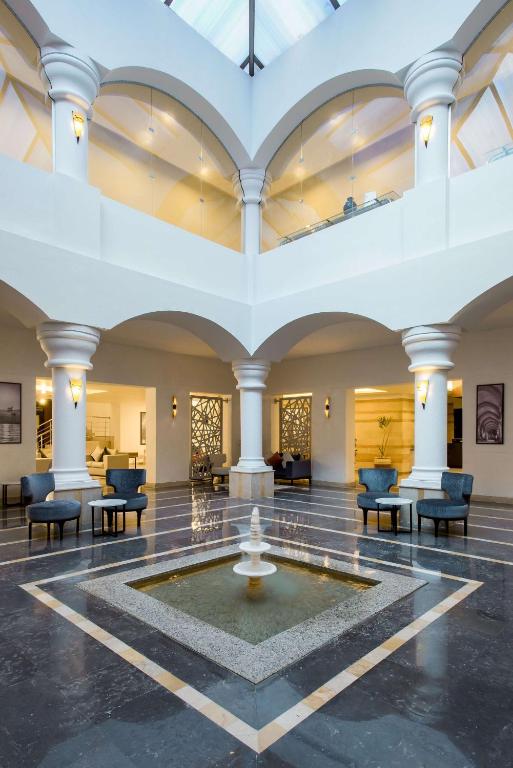 a lobby with a fountain in the middle of a room at Marina Resort Port Ghalib, a member of Radisson Individuals in Port Ghalib