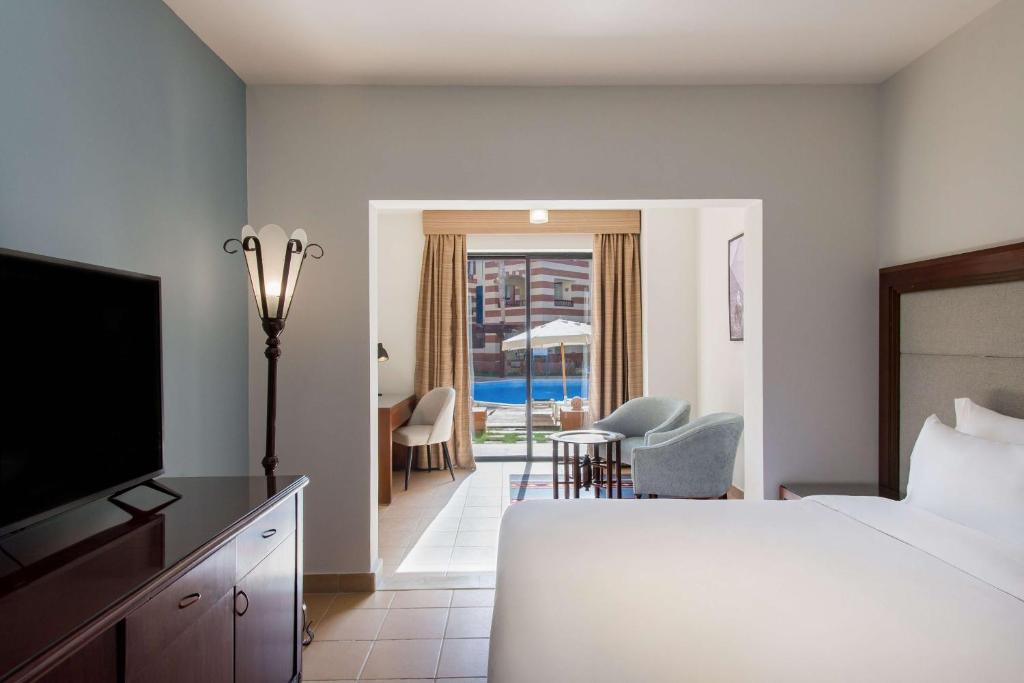 a hotel room with a bed and a television at Marina Resort Port Ghalib, a member of Radisson Individuals in Port Ghalib
