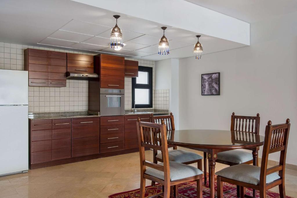 a kitchen with a table and chairs and a refrigerator at Marina Resort Port Ghalib, a member of Radisson Individuals in Port Ghalib