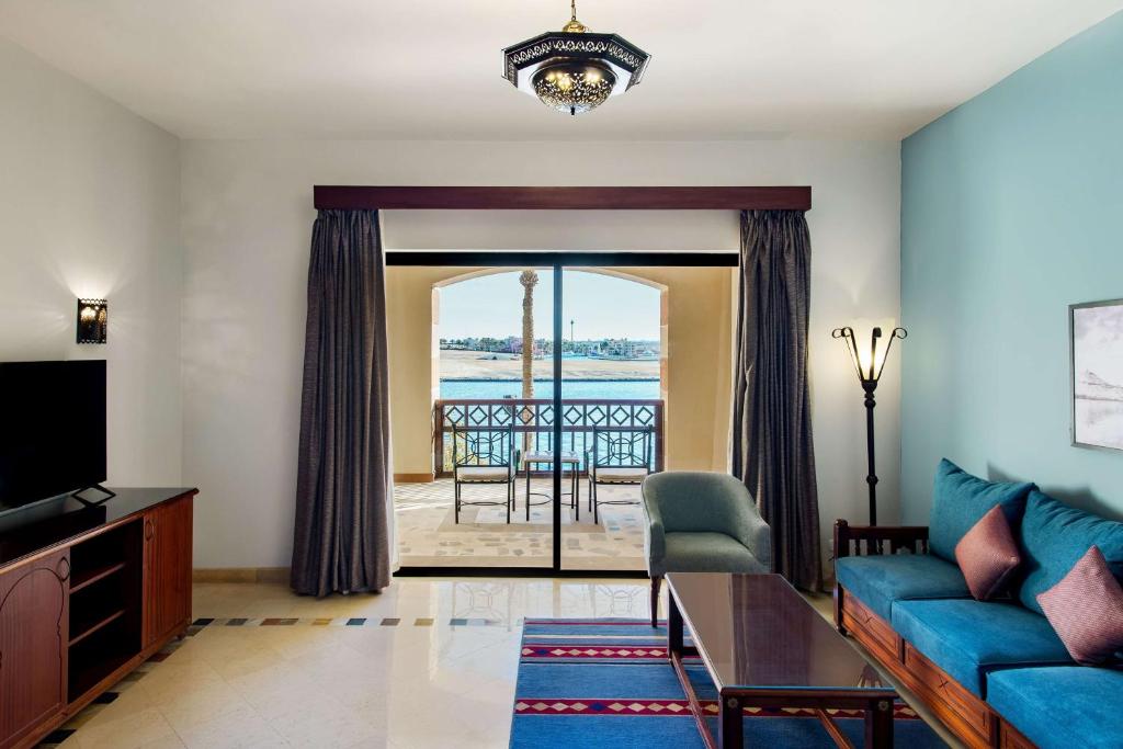 a living room with a couch and a view of the ocean at Marina Resort Port Ghalib, a member of Radisson Individuals in Port Ghalib